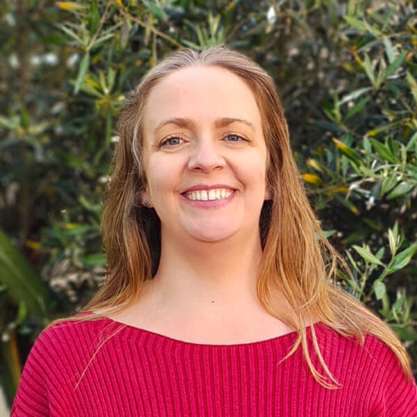 Claire Long, Practice Manager at Create Consulting Engineers, smiling outdoors wearing a pink top.