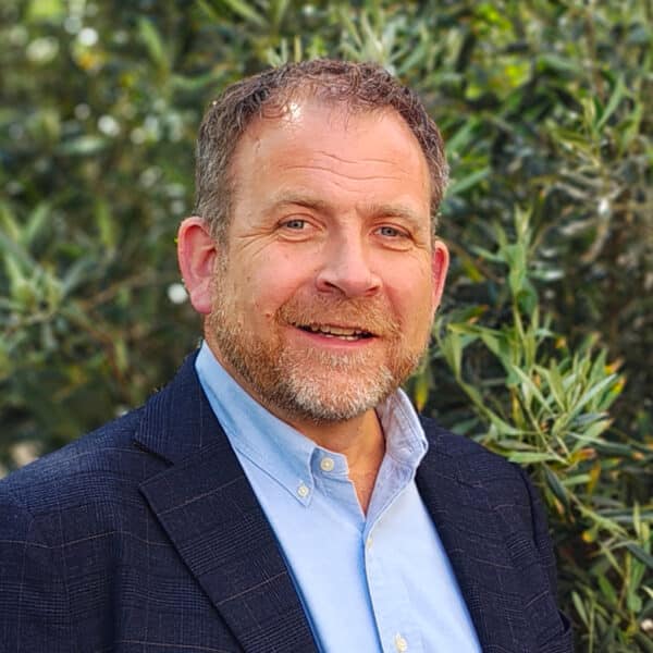 Jody Blacklock, Chartered Engineer and Acoustic Consultant at Create Consulting Engineers, outdoors against green foliage background.