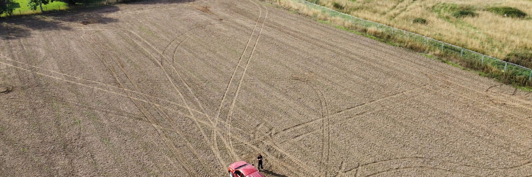 Aerial view of agricultural land with vehicle and person, representing land availability for Greater Norwich Local Plan Review Call for Sites.