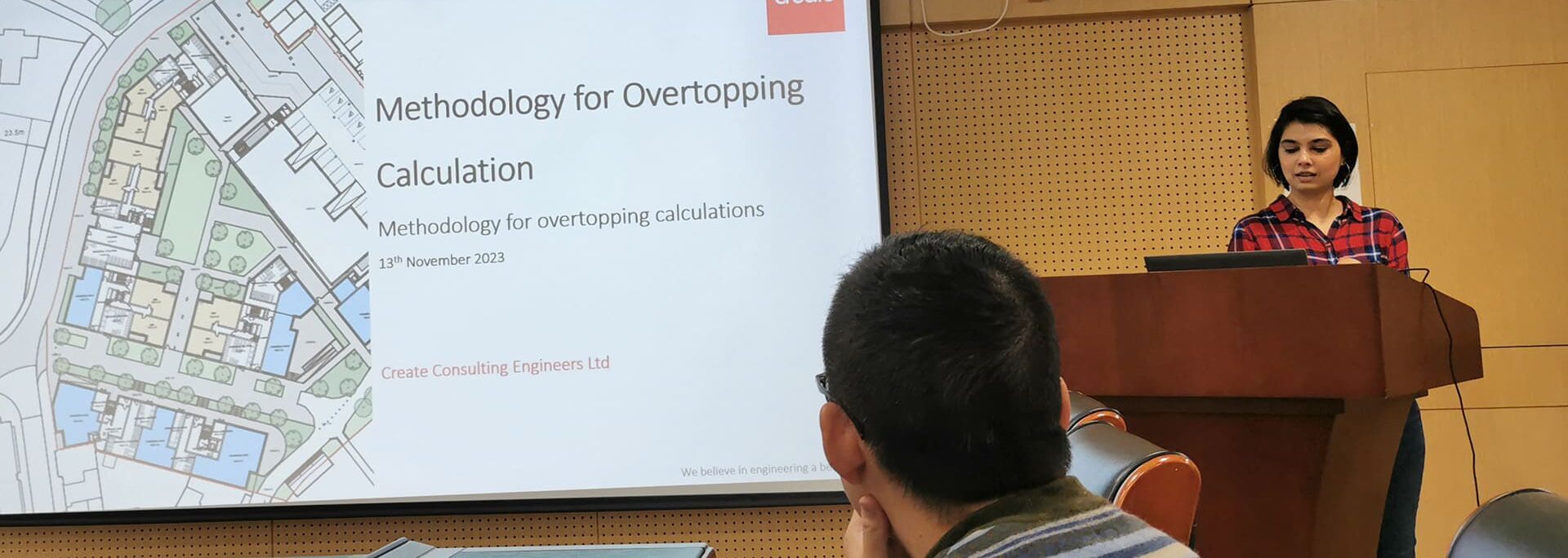 Amrie Singh presenting methodology for overtopping calculation at Create Consulting Engineers seminar, November 2023.