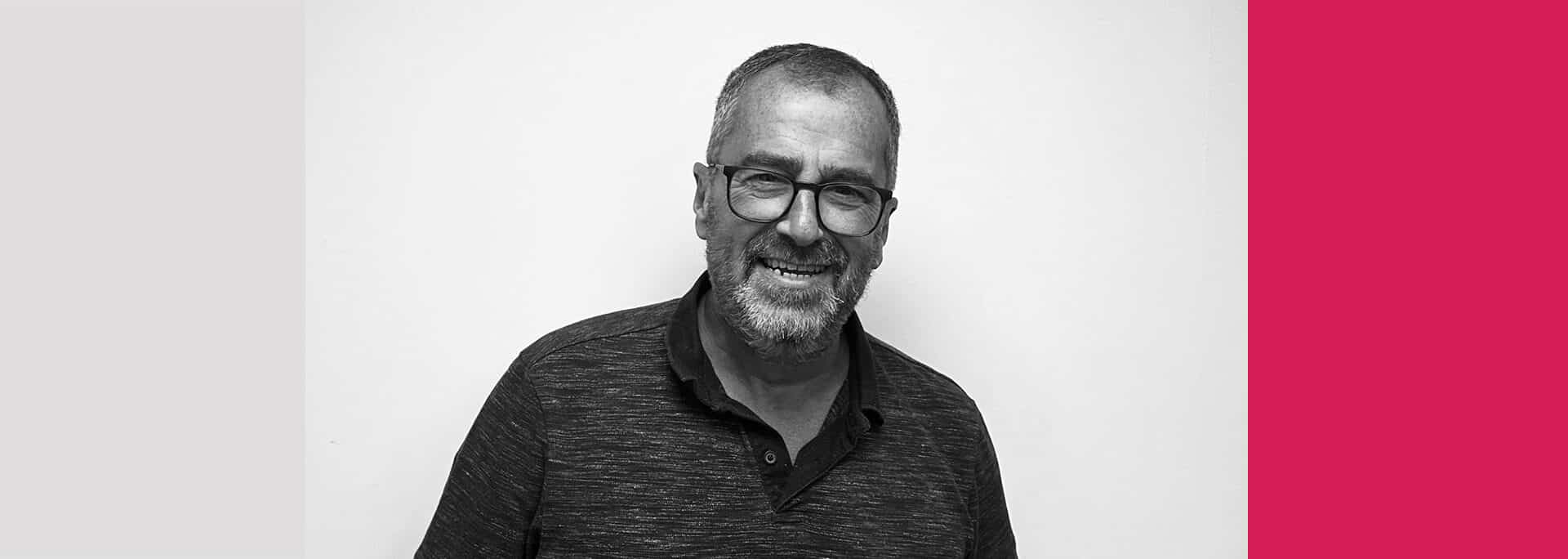 Alan DeMerquis, who leads Create Consulting Engineers' MEP Building Services team, pictured in professional headshot wearing glasses and dark shirt.