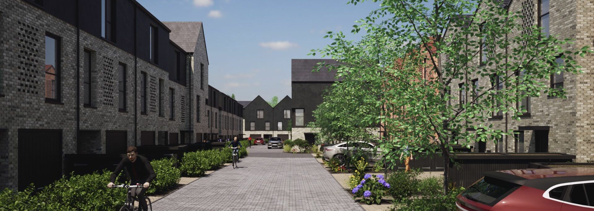 Histon Road residential development in Cambridge showing brick buildings, paved courtyard, landscaping, bicycles, and parked vehicles under clear sky.