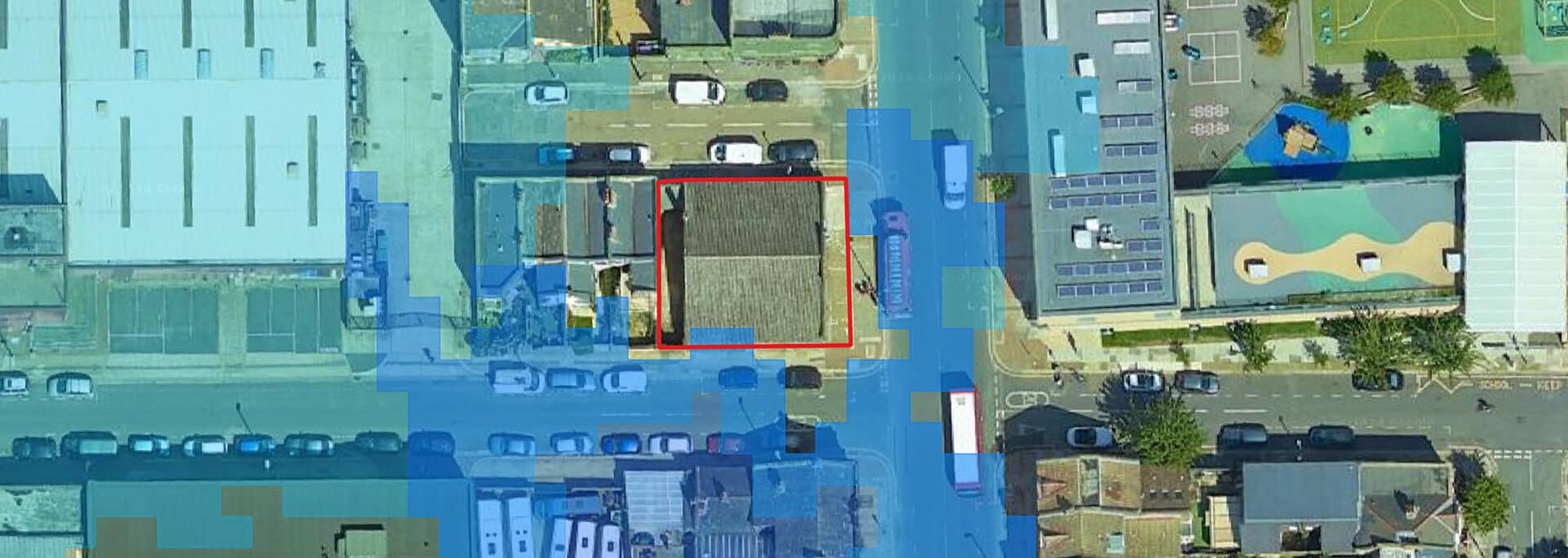 Aerial view of Wandsworth mixed-use development site with flood modelling overlay showing water risk assessment for planning approval.