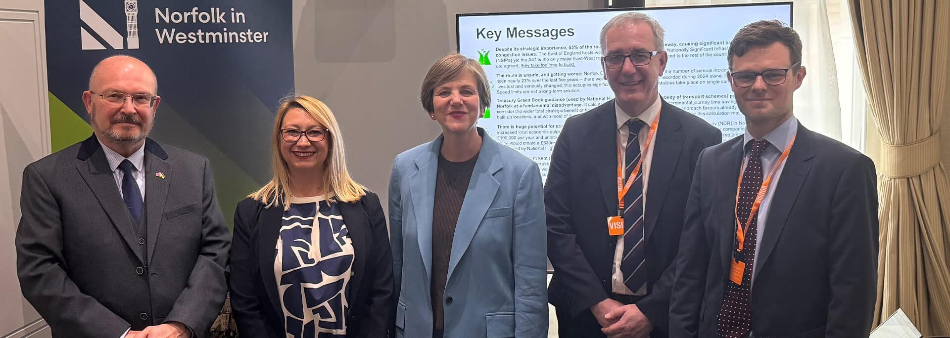 Five professionals at A47 Alliance Parliamentary Drop-In event beside Norfolk in Westminster signage and Key Messages display board.