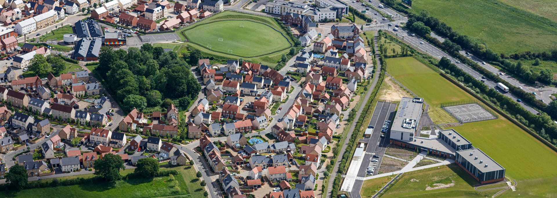 Aerial view of Kingsmere, Bicester: mixed residential development with social and affordable homes integrated into established neighbourhood, demonstrating large-scale housebuilding.