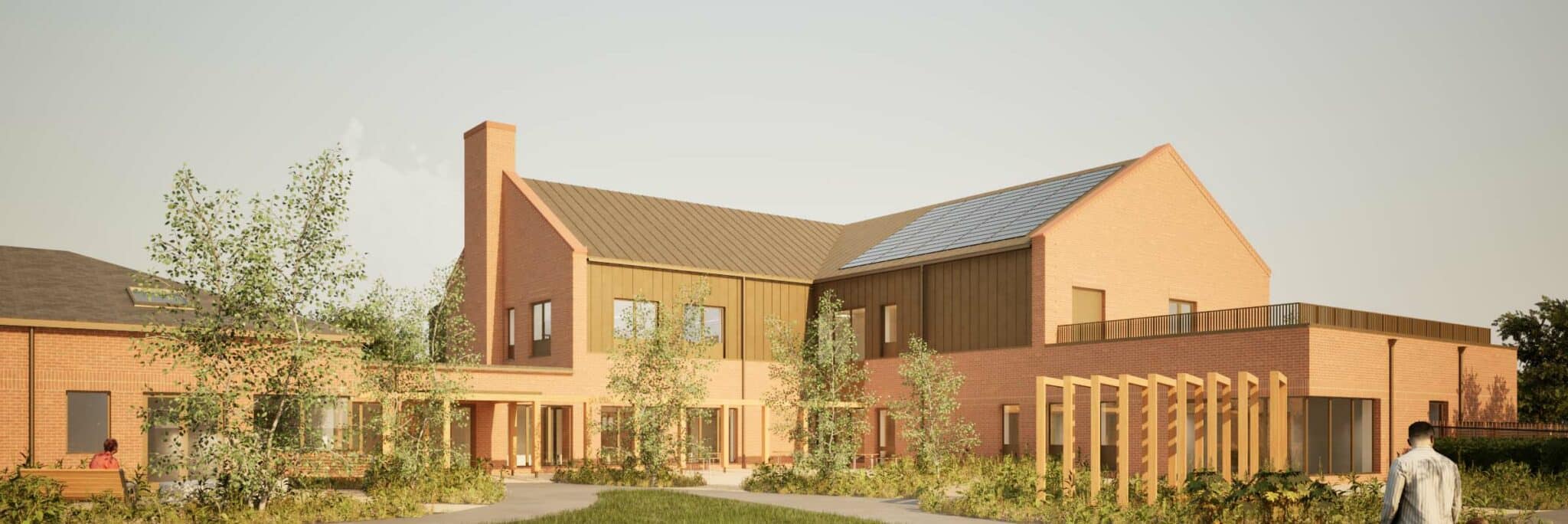 Rear courtyard elevation of Gorleston community hospice design showing brick and rendered facades with pitched roof and landscaped grounds.